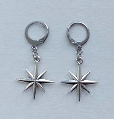 Earrings with brass pendants in the form of silver stars. Earrings attached to stainless steel hoops The total length of the earring is 4.0  cm (1.6 inches). Earrings are packed in a gift box RECOMMENDATIONS FOR CARE: Do not wet, do not drop, and store in a dark box! - Remove jewelry before exercising, swimming, showering and sleeping. - Avoid contact with moisture such as make-up, moisturizer, lotion, perfume and hairspray. - Store your jewelry in a box or pouch after use. Disneyland 2024, Stars Earrings, Huggie Earrings Silver, Brass Pendants, Earrings Star, 2024 Outfits, Gothic Grunge, Silver Snowflakes, Funky Jewelry