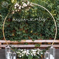 a wooden bench with candles and flowers on it next to a sign that says morgan riley