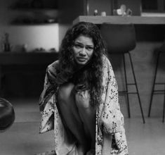 a woman with long hair sitting on the floor