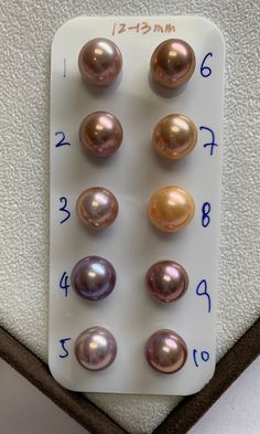 several different types of pearls on a white board