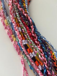 multicolored braiding on white surface with scissors