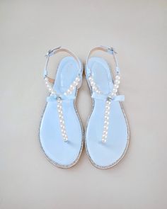 "Elegant bridal flat sandals with all pearls embellishments and small tuxedo bow with rhinestone is a combination of modern and chic that brings sophistication to the next level. Definite comfort and a perfect fit for wedding party, bridesmaids, holiday party, casual wear, or to pair with anything in your wardrobe for any occasions.  The light blue colors can easily be your something blue. You can select to have the sandal with or without bow. Details: UPPER: Synthetic upper and lining MATERIALS: Manmade outsole ORIGIN:  Imported  STYLE NAME: APOLLO-18 Not sure of which size to purchase? Shoes measurements are as follow: (Please note measurements taken the length of inside of shoe from toe to heel) WOMEN SIZE: Size 5.5 - 9.125\" Size 6 - 9.25\" Size 6.5 - 9.375 Size 7 - 9.50\" Size 7.5 - 9 Wedding Flat Sandals, Bridal Flat Sandals, Flat Sandals Wedding, Sandals Wedding, Women's Slip Ons, Pearls Wedding, Bridal Flats, Elegant Flats, Wedding Flats