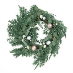 a green wreath with ornaments hanging from it