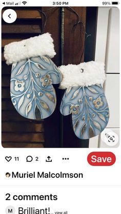 two blue and white mittens hanging from a hook