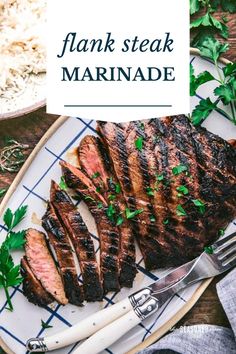 flank steak marinade on a white plate with parsley garnish and fork