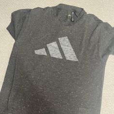 Grey Speckled T-Shirt Never Worn Trendy Adidas T-shirt With Letter Print, Basic Adidas Logo Crew Neck Tops, Adidas Logo T-shirt For Workout, Basic Adidas Crew Neck Tops, Gray Graphic Print T-shirt Athleisure, Gray Graphic Print Athleisure T-shirt, Tri-blend Short Sleeve Athleisure Top, Adidas Casual Tops With Three Stripes Branding, Tri-blend Graphic Print Sports Top