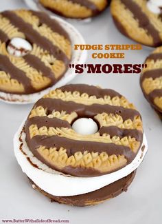 there are four cookies with chocolate frosting on them and the words fudge striped cookie s'mores