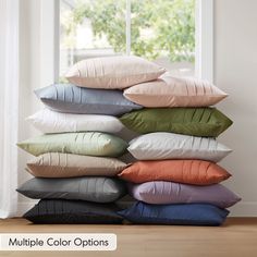 pillows stacked on top of each other in front of a window with the words multiple color options