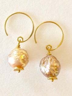 Soft peach glow Chinese freshwater Kasumi pearls wire wrapped on handmade  24k gold vermeil ear wiresBeautiful 11mm Chinese kasumi pearls with characteristic iridescent bumpy surface are full of color and texture and highly lustrous. They display a full array of metallic colors including dusty rose pink, peach and bronze. Stunning kasumi pearls are wire wrapped on 24k gold vermeil handmade ear wires with tiny gold vermeil wavy disc accents. Total length is 1 1/4”.  Also in Sterling silver. Handmade Delicate Pearl Earrings, Handmade Baroque Pearl Drop Earrings, Delicate Handmade Gold Pearl Earrings, Handmade Delicate Baroque Pearl Earrings, Delicate Handmade Baroque Pearl Earrings, Unique Pearl Drop Jewelry, Handmade Baroque Pearl Pear-shaped Earrings, Handmade Baroque Pearl Earrings In Pear Shape, Handmade Baroque Pearl Dangle Jewelry