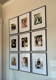 a bunch of pictures hanging on the wall with black and white frames around them,