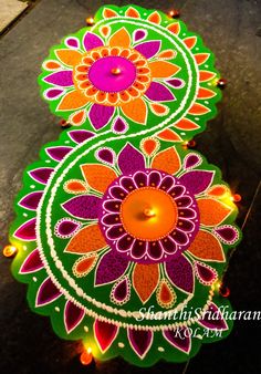 an image of colorful rangdili on the ground for diwaling with lights