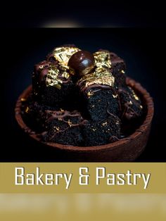 there is a chocolate cake with gold foil on it and the words bakery & pastry