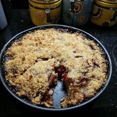 a pie sitting on top of a pan covered in crumbs