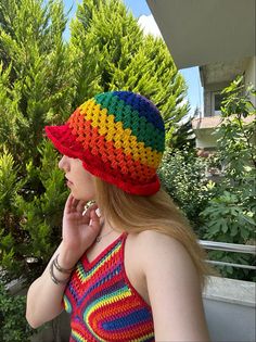 a woman wearing a multicolored knitted hat on her cell phone and talking on the phone