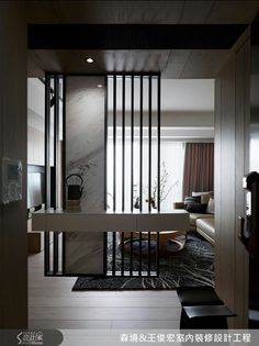 an open door leading to a living room with black and white decor on the walls