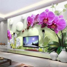 the living room is decorated with orchids and other things in white vases on the table