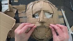 someone is making a mask out of cardboard