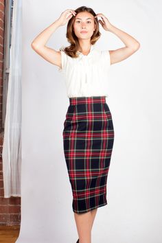 "Classic pencil skirt silhouette with a slightly longer hem, wool blend tartan on front and waistband, offset with black ponte stretch panel on back for a more fitted look. Invisible zipper closure and hem slit on back.  Composition: 70% Polyester, 30% Wool Contrast Fabric: 65% Rayon, 31% Nylon, 4% Spandex Care: Dry clean only Garment Measurements: Laid Flat Waist (No Stretch): XXS - 24\"  XS - 26\"  S - 28\"  M - 30\"  L - 32\"  XL - 34\"  XXL - 36\" Laid Flat Hip (Some Stretch): XXS - 34\"  XS Tartan Midi Skirt, Scottish Skirt, 50s Outfits, Dressy Flats, 40 Fashion Women, Work Skirt, Fall Beauty, Plaid Pencil Skirt, Short Women Fashion