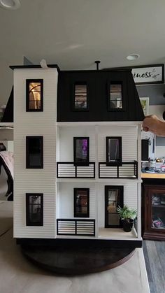 a model house being held up by a person