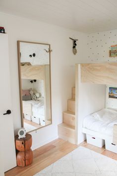 a bedroom with bunk beds and mirrors on the wall