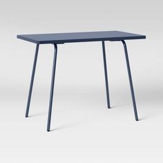 a blue table sitting on top of a white floor