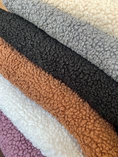 several colors of towels stacked on top of each other