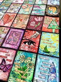 many different colored cards are arranged on a table with the words and pictures in them