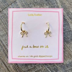 Beautiful Bow Charm Hoop Gold Earrings - Lyla's: Clothing, Decor & More - Plano Boutique Elegant Huggie Earrings With Charms For Gift, Elegant Huggie Earrings With Charms As Gifts, Dainty Hoop Earrings For Party, Dainty Hoop Earrings With Charms For Gifts, Dainty Charm Hoop Earrings As Gift, Delicate Dangling Charms Earrings, Dainty Hoop Earrings With Charms As Gift, Dainty Hoop Earrings With Dangling Charms As Gift, Elegant Hoop Earrings With Dangling Charms For Gift