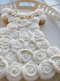 cupcakes in the shape of a teddy bear are on a plate with white icing