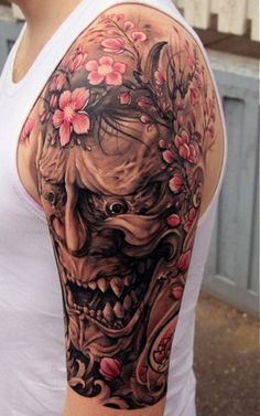 a woman with a skull and flowers on her arm