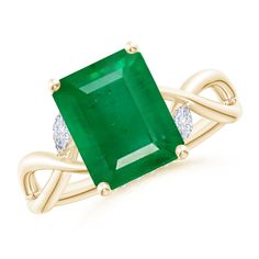 an emerald and diamond ring in yellow gold