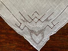 "This beautiful vintage linen pulled thread handkerchief measures approximately 10.5\" square and has a rolled hem bordered by pull work. The work is done in such a way that the edges are slightly scalloped. There is a pulled work heart on all corners as well as white on white embroidery. It's in excellent vintage condition, with no holes, tears, or stains that I can see. A lovely hankie! This would be a great gift for a bride. Please look carefully at photos for details as you may be able to make out something I don't see. If you find a flaw that I have missed, I'd be grateful for a message so I can provide a more accurate description. Thanks for visiting our Etsy shop! Please check out our other listings as well - we have quite a few handkerchiefs and are adding more all the time.  **We White On White Embroidery, White Handkerchief, Vintage Hankies, White On White, Vintage Linen, White Embroidery, Rolled Hem, Heart On, Vintage Linens