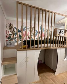 there is a loft bed with built in desks underneath it and shelves below the stairs