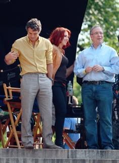 two men and a woman on the set of a movie