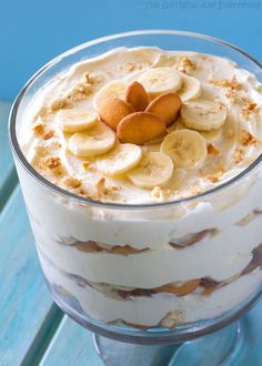 an image of a dessert with bananas and cream in the center on a blue table