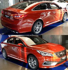 an orange car parked in a garage next to another red car