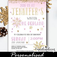 a pink and gold winter birthday party with snowflakes, pine cones and decorations