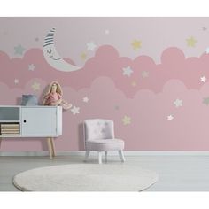 a child's room with stars and clouds painted on the wall, including a pink chair