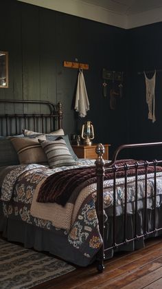 a bed sitting on top of a wooden floor in a bedroom