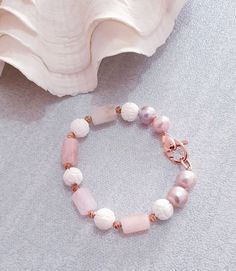 "Pink Pearl, morganite, White shell beaded bracelet made with natural pearl, gemstone and 18 kt rose gold filled clasp. Bracelet Length: 7 \" Morganite  Barrel  : 15x8  mm  pink round  pearl:  10 mm white shell carved bead : 10 mm  Italian made rose gold filled Clasp: 25x10mm The bracelet is hand knotted with silk thread . It is nice and comfortable for everyday wear and it comes with the beautiful package which are ready for gift giving. Please feel free to message me if you want to see more photos . SHOP BRACELET: https://www.etsy.com/il-en/shop/kennariesjewellery/search?search_query=bracelet&order=date_desc&view_type=gallery&ref=shop_search CLICK HERE TO RETURN TO MY SHOP: http://www.kennariesjewellery.etsy.com Please feel free to message me if you want to see more photos. Worldwide fre Elegant Hand-strung Rose Quartz Crystal Bracelet, Elegant Rose Quartz Gemstone Beaded Bracelets, Elegant Rose Gold Bracelets With Natural Stones, Elegant Rose Quartz Gemstone Beaded Bracelet, Elegant Rose Gold Bracelet With Natural Stones, Rose Gold Beaded Bracelets With Gemstone Beads, Elegant Pink Bracelets With Natural Stones, Elegant Beaded Rose Quartz Crystal Bracelet, Handmade Rose Gold Rose Quartz Beaded Bracelet