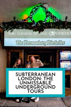 two people standing in front of a sign that says the london bridge experience and the birmingham birthday celebration