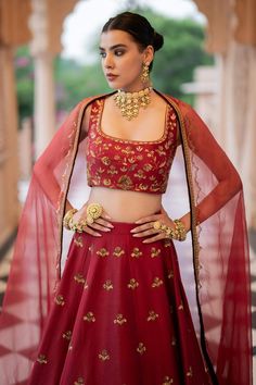 Maroon lehenga with an attached cancan and nakshi and sequins embroidery. Comes with a padded blouse and a dupatta.
Components: 3
Pattern: Embroidered
Type Of Work: Nakshi, Sequins
Neckline: Square Neck
Sleeve Type: Sleeveless
Fabric: Chanderi, Semi crepe, Organza, Lining: Semi crepe
Color: Maroon
Other Details: 
Attached lining
Product Weight: 2 Kg
Model Height: 5ft 9inches, wearing size S
Closure:
Lehenga: Side zip
Blouse: Back hooks
Note: Jewellery worn by the model is not for sale.
Occasion: Transitional Wedding Anarkali Set With Unstitched Blouse, Transitional Season Wedding Anarkali Set With Unstitched Blouse, Traditional Unstitched Blouse Set For Reception, Transitional Georgette Lehenga With Dupatta, Semi-stitched Tilla Sharara For Festivals, Kundan Set With Unstitched Blouse For Eid, Navratri Bollywood Style Blouse With Tilla Details, Festive Lehenga With Unstitched Blouse, Chanderi Lehenga For Reception And Transitional Season