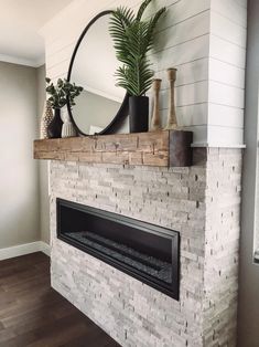 a white brick fireplace with a mirror above it