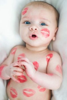 a baby with pink and red spots on it's body