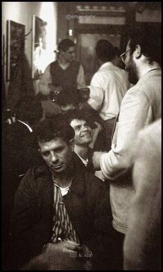 black and white photograph of men sitting in a room