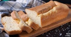 a loaf of bread sitting on top of a wooden cutting board