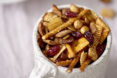 a white bowl filled with cereal and nuts