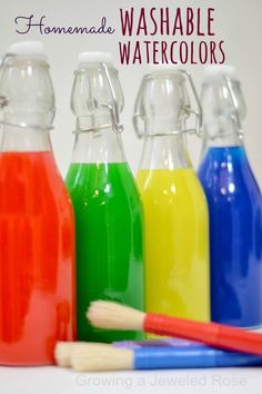 three different colored glass bottles with toothbrushes next to them and the words homemade washable watercolors