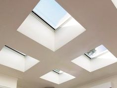 a living room filled with furniture and skylights