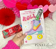 a person holding up a card with roller skates on it and candy bar in front of them